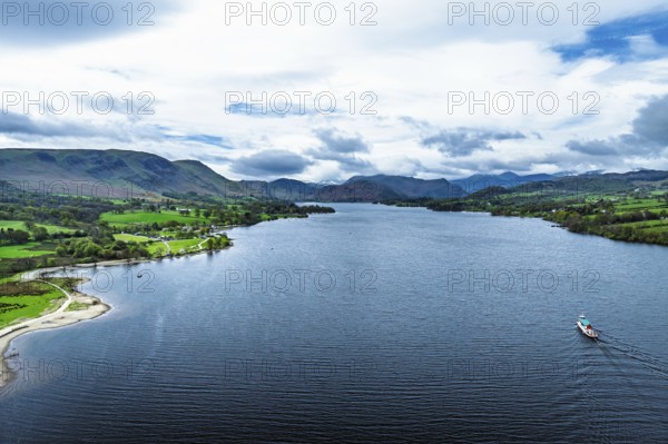 Farms and mountains over Ullswater Lake from drone, Pooley Bridge, Lake District National Park, Cumbria, England, United Kingdom
