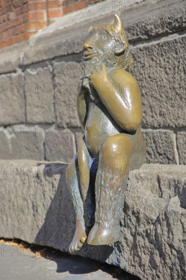Sculpture Devil by Rolf Goerler 1999 sitting on the Devil's Stone, bronze sculpture, modern art, St. Mary's Church, Old Town, Lübeck, Schleswig-Holstein, Germany