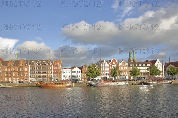 Ships on the banks of the Stadttrave, houses, cityscape, sailing ship, harbour, steeples of St. Mary's Church, light mood, old town, Lübeck, Schleswig-Holstein, Germany