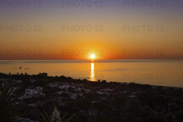The sun rises on the Costa Rei, a stretch of coastline on the Italian Mediterranean island of Sardinia, Monte Nai, Costa Rei, Sardinia, Italy