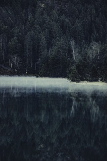 Sunrise with reflections in the Plansee in Tyrol in the Alps in Austria