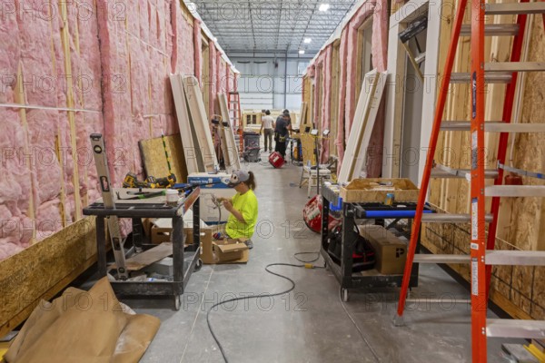 Romulus, Michigan - Workers build apartments in Ginosko Modular 's factory using modular construction methods. The units will be assembled into an apartment building in Detroit for low to moderate income households