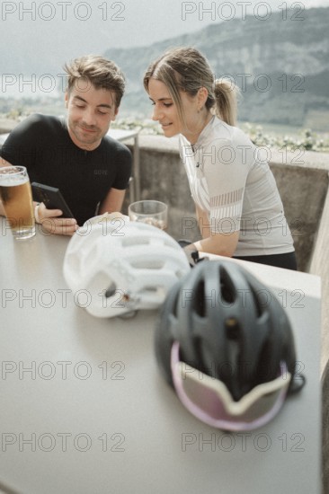 Young man taking a coffee break while riding his racing bike on Lake Garda. Sunny weather and dolce vita