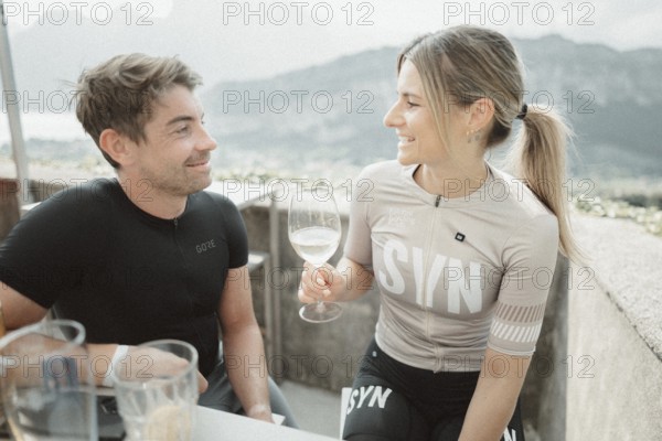 Young man taking a coffee break while riding his racing bike on Lake Garda. Sunny weather and dolce vita
