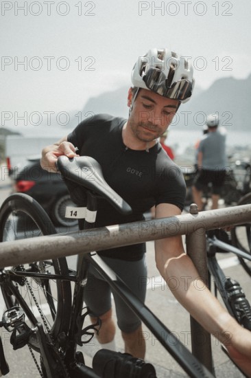 Young man riding a racing bike on Lake Garda. Sunny weather and dolce vita
