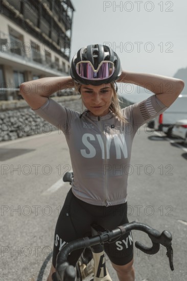 Young woman riding a racing bike on Lake Garda. Sunny weather and dolce vita