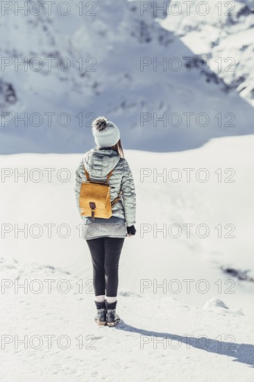 Woman in wintry surroundings in the Engadine in Switzerland
