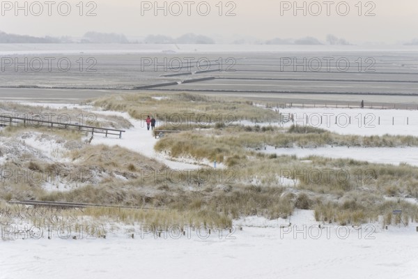View over the snow-covered dune landscape of Norddeich, Wadden Sea at low tide, North Sea, Lower Saxony, Germany
