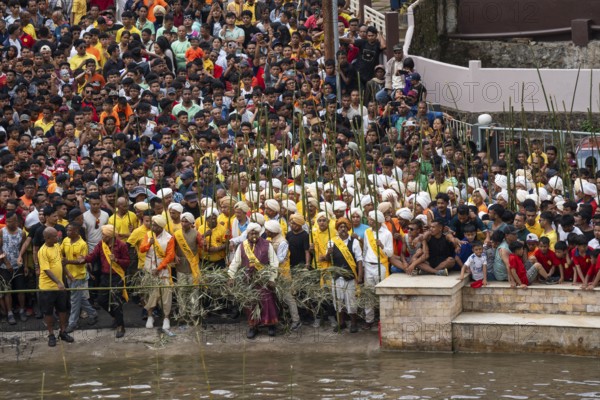 JOWAI, INDIA - JULY 14: People from the Pnar community attend the Behdienkhlam festival in Jowai, India on July 14, 2025. Behdienkhlam is a vibrant annual festival celebrated by the Pnar (Jaintia) community of Meghalaya, especially in Jowai, to drive away plague and diseases and to pray for a good harvest. Observed in July after the sowing season, it features traditional rituals, offerings to ancestral spirits, and the grand procession of beautifully decorated bamboo structures called rots, which are later immersed in a sacred muddy pool known as Ka Aitnar