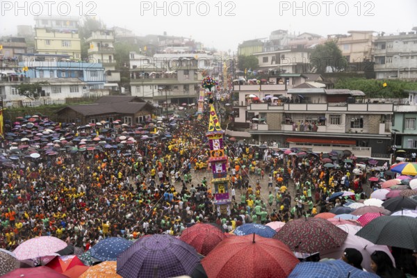 People from the Pnar community march in a circle around a Rot as they celebrate an event organised to mark the Behdienkhlam festival in Jowai, India on July 14, 2025. Behdienkhlam is a vibrant annual festival celebrated by the Pnar (Jaintia) community of Meghalaya, especially in Jowai, to drive away plague and diseases and to pray for a good harvest. Observed in July after the sowing season, it features traditional rituals, offerings to ancestral spirits, and the grand procession of beautifully decorated bamboo structures called rots, which are later immersed in a sacred muddy pool known as Ka Aitnar