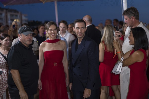 Hilary Swank and Marcel Remus walk through the crowd at the Remus Lifestyle Night on the rooftop terrace of the Pure Salt Hotel in El Toro, Magaluf, Majorca, Spain on 31/07/2025