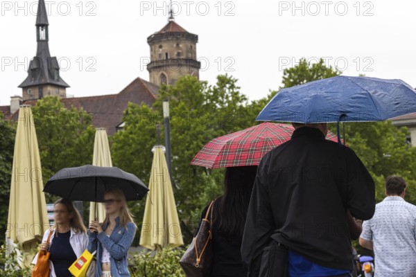 Rainy weather in Stuttgart. People with umbrellas hurry through the rain on Königstraße. Stuttgart, Baden-Württemberg, Germany