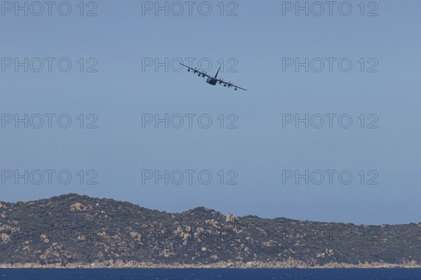 A Lockheed Martin MC-130J Commando II, a US Air Force military aircraft, flies low over Costa Rei, a coastal area of the Italian Mediterranean island of Sardinia, Monte Nai, Costa Rei, Sardinia, Italy