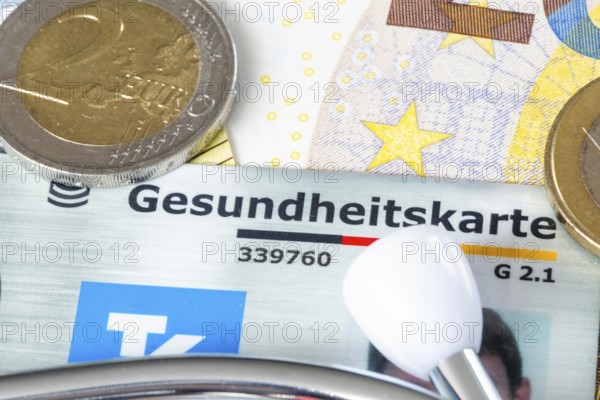 Health insurance contributions Symbolic image: health card, stethoscope and cash