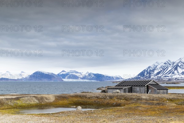 Wooden house against a mountain backdrop, Ny-Alesund, Spitsbergen, Svalbard
