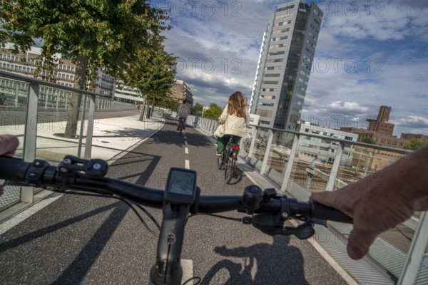 Cycling over the Moreelsebrug, pedestrian and cyclist bridge over the tracks of Utrecht Centraal, Central Station, Rabobank