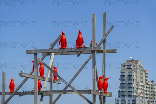 Rode Pinguins, Red Penguins, artwork by Belgian artist William Sweetlove in the harbour of Breskens along the Western Scheldt, Zeeland, Netherlands