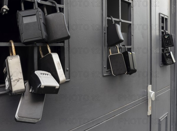 Key boxes on a grille of a basement window for flat flats in the city centre of Bratislava, Slovakia