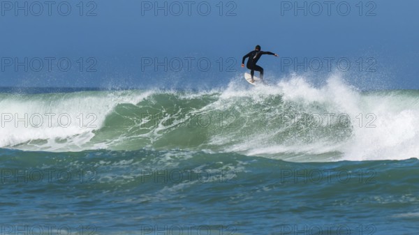 Surfer riding a wave on Contis beach, Saint Julien en Born, Saint-Julien-en-Born, Landes, France