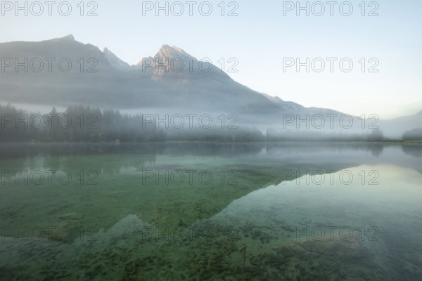 Magical sunrise with fog at Hintersee near Ramsau in Berchtesgadener Land