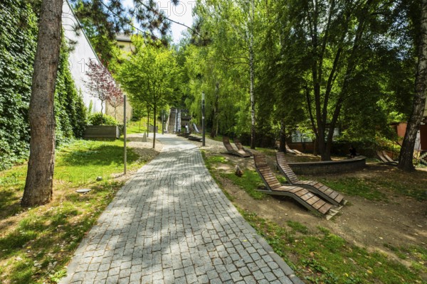 Small park with seating, a playground and a fountain at the entrance to Trencin Castle, Capital of Culture 2026, Trencín, Slovakia