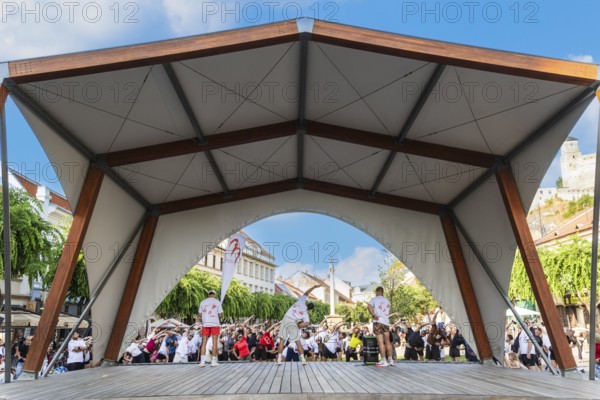An event by a local fitness centre takes place on a stage on Peace Square, Capital of Culture 2026, Trencín, Slovakia
