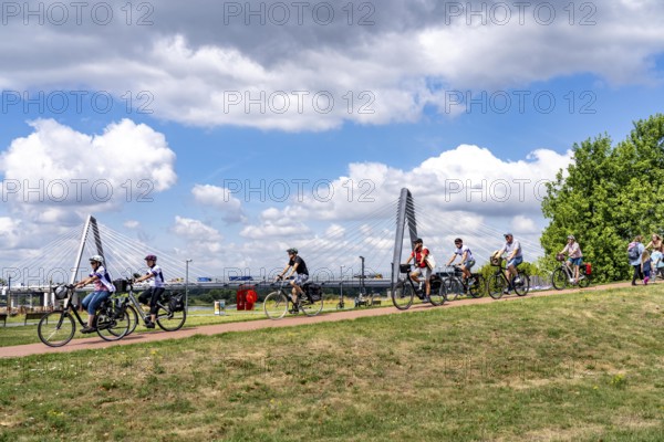 Cycle path in the Neulandpark in Leverkusen on the Rhine, in the background the new Rhine bridge of the A1, 1 construction phase, near Leverkusen, participants of the North Rhine-Westphalia Cycle Tour, 4-day, 220 KM long round trip through the Rhineland, with over 1400 participants, North Rhine-Westphalia, Germany