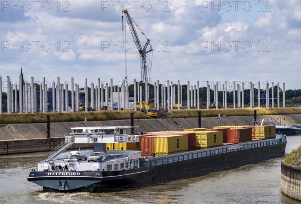 Construction of a new logistics hall on the Mercatroinsel, Hall 2, next to an existing hall, approx. 25, 000 square metres in size, in Duisburg-Ruhrort, shell construction, container freighter leaving the Vincke Canal for the Rhine, North Rhine-Westphalia, Germany