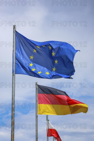 Düsseldorf, North Rhine-Westphalia, Germany - European flag, German flag and North Rhine-Westphalia flag fluttering in the wind on flagpoles, symbolic image of EUROPA