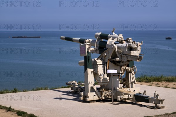 German 8, 8 cm gun, cannon, anti-aircraft gun, behind it Phoenix Caissons, caissons, concrete boxes, were used in the sea as breakwaters and to form an improvised harbour, Mulberry B Harbour, Mulberry Harbour, Port Winston, Gold Beach, beach, D-Day, Operation Overlord, Atlantic Wall, Arromanches-les-Bains, Normandy, Calvados, France