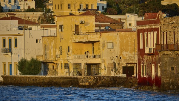 Old, colourful buildings on the water illuminated by the evening sun, quiet coastal feeling, Agia Marina, Leros, Dodecanese, Greek Islands, Greece