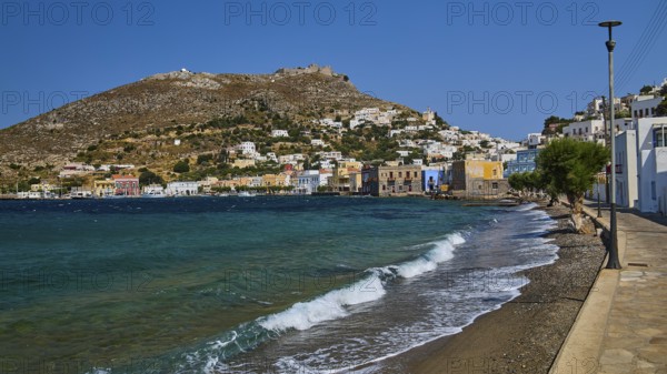 Panteli Fortress, seafront promenade of a coastal town with waves and beautiful hills, Agia Marina, Leros, Dodecanese, Greek Islands, Greece
