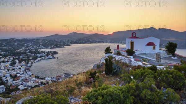 Profitis Ilias Church, A red-roofed church overlooks the bayside village at sunset, creating an idyllic atmosphere, Ormos Alintas, Agia Marina, Leros, Dodecanese, Greek Islands, Greece