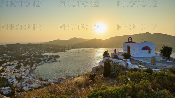 Profitis Ilias Church, Small church on a hill overlooking the calm sea at sunset, surrounded by a picturesque village, Ormos Alintas, Agia Marina, Leros, Dodecanese, Greek Islands, Greece