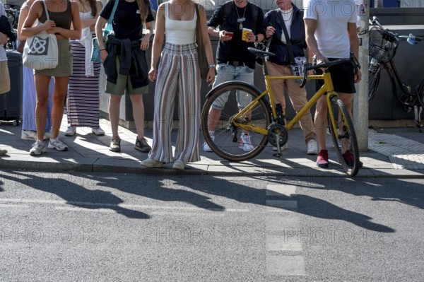 Passers-by waiting at a pedestrian crossing, Munich, Bavaria, Germany