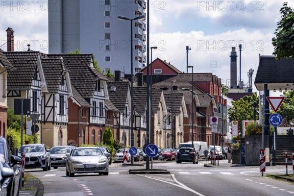 Residential buildings, on Nobelstrasse, in the Wiesdorf district, in Leverkusen, Bayer AG's Plant Estate II, heritage-protected building, in the background residential tower block and Bayer Cross in Chempark Leverkusen, North Rhine-Westphalia, Germany