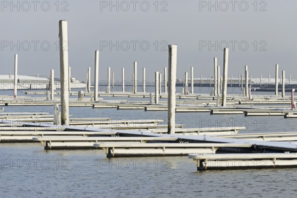Winter day, onset of winter, snow on the jetties in the marina, North Sea, Norddeich, Lower Saxony, Germany