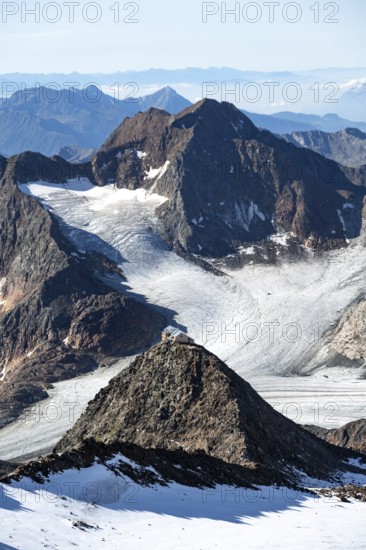 At the Wilder Freiger summit, picturesque high mountain landscape with snow, view of the Übeltalferner glacier and rocky mountain peaks Becher with Becherhaus and Königshofspitz, Stubai Alps, South Tyrol, Italy
