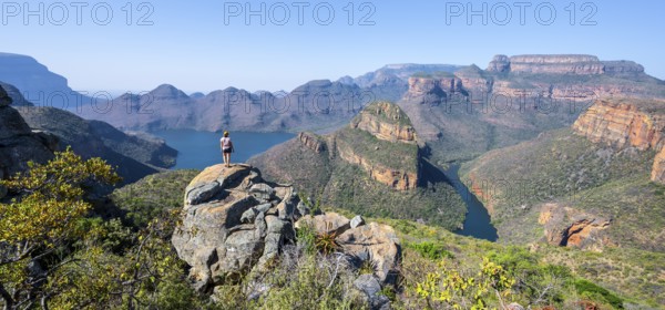Hiker enjoying panorama, Blyde River Canyon with summit Three Rondawels, view of canyon with river Blyde River and table mountains, canyon landscape, Panorama Route, Mpumalanga, South Africa