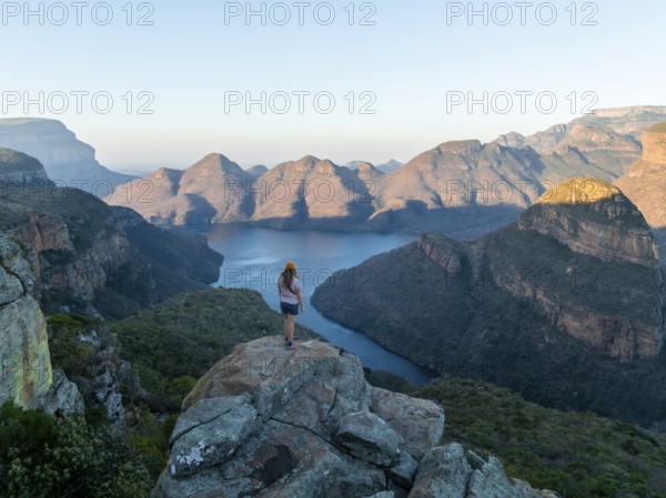 Hiker enjoying panorama, Blyde River Canyon with summit Three Rondawels, view of canyon with river Blyde River and table mountains, canyon landscape, Panorama Route, Mpumalanga, South Africa
