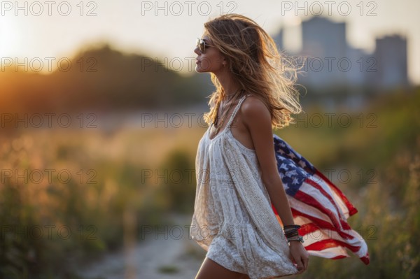 Beautiful attractive patriotic young woman with the American flag held in her standing in the summer sunset. Love for the country and american lifestyle, AI generated