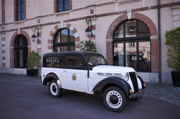 Black and white Renault Juvaquatre Editorial vintage car in front of headquarters, head office, Atelier 1834 Champagne Boizel, Avenue de Champagne, Épernay, Marne, France