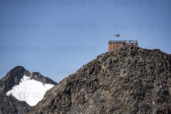 Becherhaus mountain hut on the summit of the Becher, helicopter to supply the mountain hut, Stubai Alps, South Tyrol, Italy