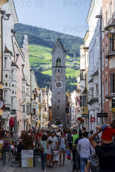 Old town, colourful houses in the main street, Zwölferturm tower at the back, old town, Sterzing, South Tyrol, Italy