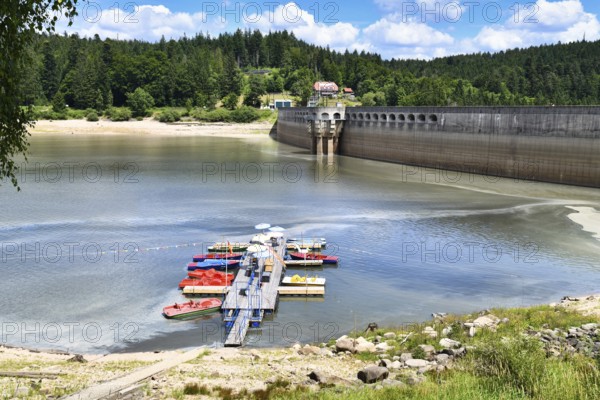Schwarzenbach Dam (German: Schwarzenbachtalsperre) and reservoir in Forbach in the Northern Black Forest in Germany with boat dock and rental on a sunny summer day