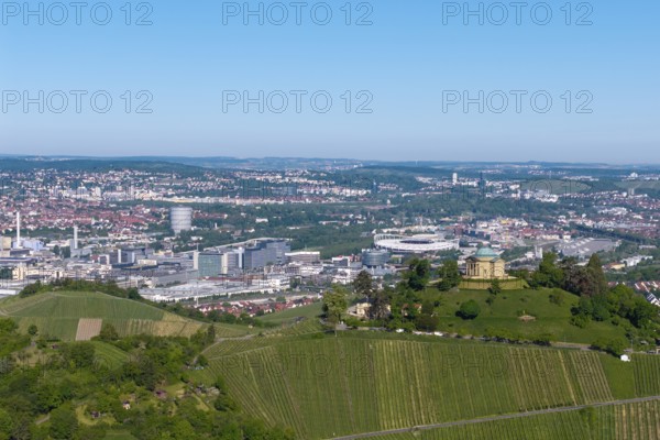 Vineyards and green hill with a building, city panorama in the background, view of the burial chapel of Stuttgart-Rotenberg, in the background the Mercedes-Benz plant in Stuttgart-Untertürkheim and the MHP Arena, Baden-Württemberg, Germany