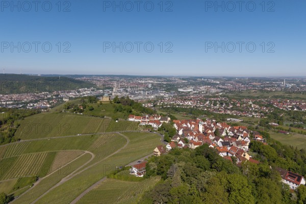 Panorama of a town with vineyards and red roofs under a clear sky, view of Rotenberg near Stuttgart with a burial chapel, in the background the Mercedes-Benz plant in Stuttgart-Untertürkheim and the MHP Arena, Baden-Württemberg, Germany