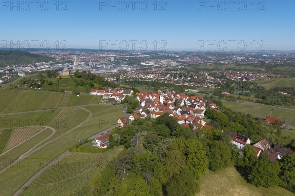 View of a city with surrounding nature and vineyards under a blue sky, view of Rotenberg near Stuttgart with a burial chapel, in the background the Mercedes-Benz plant in Stuttgart-Untertürkheim and the MHP Arena, Baden-Württemberg, Germany