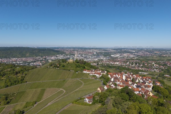 Urban landscape with vineyards, red roofs and fields under a blue sky, view of Rotenberg near Stuttgart with burial chapel, in the background the Mercedes-Benz plant in Stuttgart-Untertürkheim and the MHP Arena, Baden-Württemberg, Germany