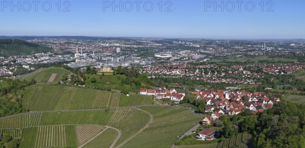 Panoramic view of a town with surrounding vineyards under a clear blue sky, view of Rotenberg near Stuttgart with a burial chapel, in the background the Mercedes-Benz plant in Stuttgart-Untertürkheim and the MHP Arena, Baden-Württemberg, Germany